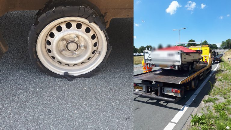 Volle aanhanger met vernielde band op oprit Nollenweg