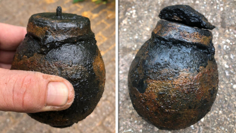 Twee beelden van een roestige oude granaat met een ronde vorm en een beschadigd oppervlak, vastgehouden door een hand; de eerste foto toont de bovenkant met een ontsteekmechanisme en de tweede een zijaanzicht met een dekseltje dat loszit.